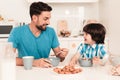 Smiling Son and Father Have Breakfast in Kitchen. Royalty Free Stock Photo