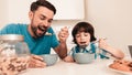 Smiling Son and Father Have Breakfast in Kitchen Royalty Free Stock Photo