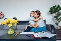 Smiling son hugging his happy mother during home family weekend Mother and son drawing with color pencils and markers in Royalty Free Stock Photo