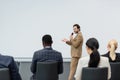 Smiling speaker talking and pointing with Royalty Free Stock Photo