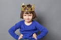 Smiling spoiled kid with golden crown on