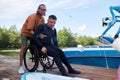 Smiling sports instructor assisting man with disability for water sports