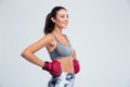 Smiling sports woman standing in boxing gloves