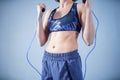 Smiling sportswoman posing with a skipping rope. Female with muscular body posing with jump rope. Fitness model. Body Royalty Free Stock Photo