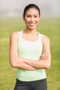 Smiling sporty woman with arms crossed Royalty Free Stock Photo