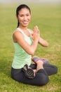 Smiling sporty woman doing the lotus pose Royalty Free Stock Photo