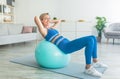 Smiling Sporty Woman Exercising Leaning On Ball At Home Royalty Free Stock Photo