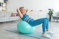 Smiling Sporty Woman Exercising Leaning On Fitness Ball At Home Royalty Free Stock Photo