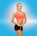 Smiling sporty woman with measuring tape Royalty Free Stock Photo