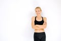 Smiling sporty woman portrait with crossed arms against white wa Royalty Free Stock Photo