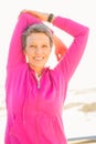 Smiling sporty woman stretching arms at promenade Royalty Free Stock Photo