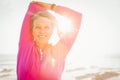 Smiling sporty woman stretching arms at promenade Royalty Free Stock Photo