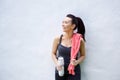 Smiling sporty woman with water bottle and towel Royalty Free Stock Photo