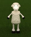 Smiling standing sheep on green grass Royalty Free Stock Photo