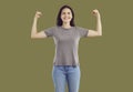 Smiling strong powerful young woman showing her biceps Royalty Free Stock Photo