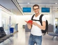 Smiling student with backpack and book at airport Royalty Free Stock Photo
