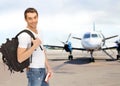 Smiling student with backpack and book at airport Royalty Free Stock Photo