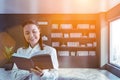 Smiling student with book in home library Royalty Free Stock Photo