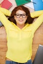 Smiling student in eyeglasses lying on floor Royalty Free Stock Photo