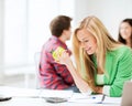 Smiling student girl eating apple at school Royalty Free Stock Photo