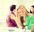 Smiling student girl eating apple at school Royalty Free Stock Photo