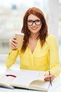 Smiling student girl reading books in library Royalty Free Stock Photo