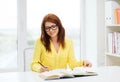 Smiling student girl reading books in library Royalty Free Stock Photo