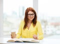 Smiling student girl reading books in library Royalty Free Stock Photo