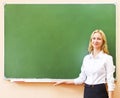 Student girl standing near blackboard in the classroom Royalty Free Stock Photo