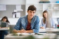 Smiling student guy preparing for exam at school Royalty Free Stock Photo