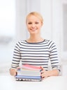 Smiling student with laptop, books and notebooks Royalty Free Stock Photo