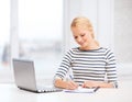 Smiling student with laptop computer and documents Royalty Free Stock Photo