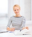 Smiling student with laptop computer and documents Royalty Free Stock Photo