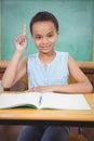 Smiling student with a rasied hand