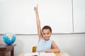 Smiling student with a rasied hand Royalty Free Stock Photo