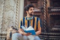 Student reading a book outdoor, studying and preparing for exams at the university or college Royalty Free Stock Photo