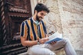 Student reading a book outdoor, studying and preparing for exams at the university or college Royalty Free Stock Photo