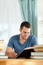 Smiling student reviewing his subject material