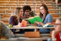 Smiling studentÃ¢â¬â¢s discussion and writing together at college Royalty Free Stock Photo