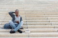 Smiling student sitting on stairs using tablet Royalty Free Stock Photo