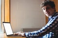 Smiling student using laptop in college Royalty Free Stock Photo