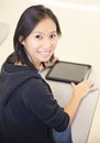 Smiling student using a tablet computer