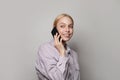 Smiling student young woman wearing casual clothes talking on phone against white studio wall banner background Royalty Free Stock Photo