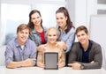 Smiling students with blank tablet pc screen