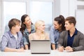 Smiling students with laptop at school Royalty Free Stock Photo