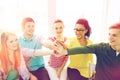 Smiling students making high five gesture sitting Royalty Free Stock Photo