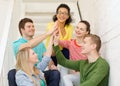 Smiling students making high five gesture sitting Royalty Free Stock Photo