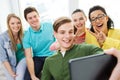 Smiling students making selfie with tablet pc