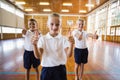 Smiling students showing thumbs up in school gym Royalty Free Stock Photo