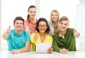 Smiling students with tablet pc computer at school